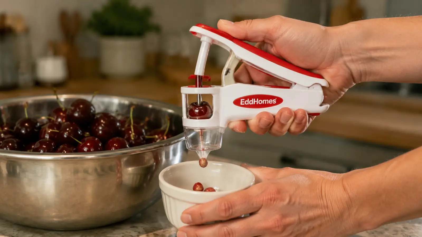 Hand squeezing the EddHomes 7-in-1 cherry pitter over a bowl, pit popping out cleanly