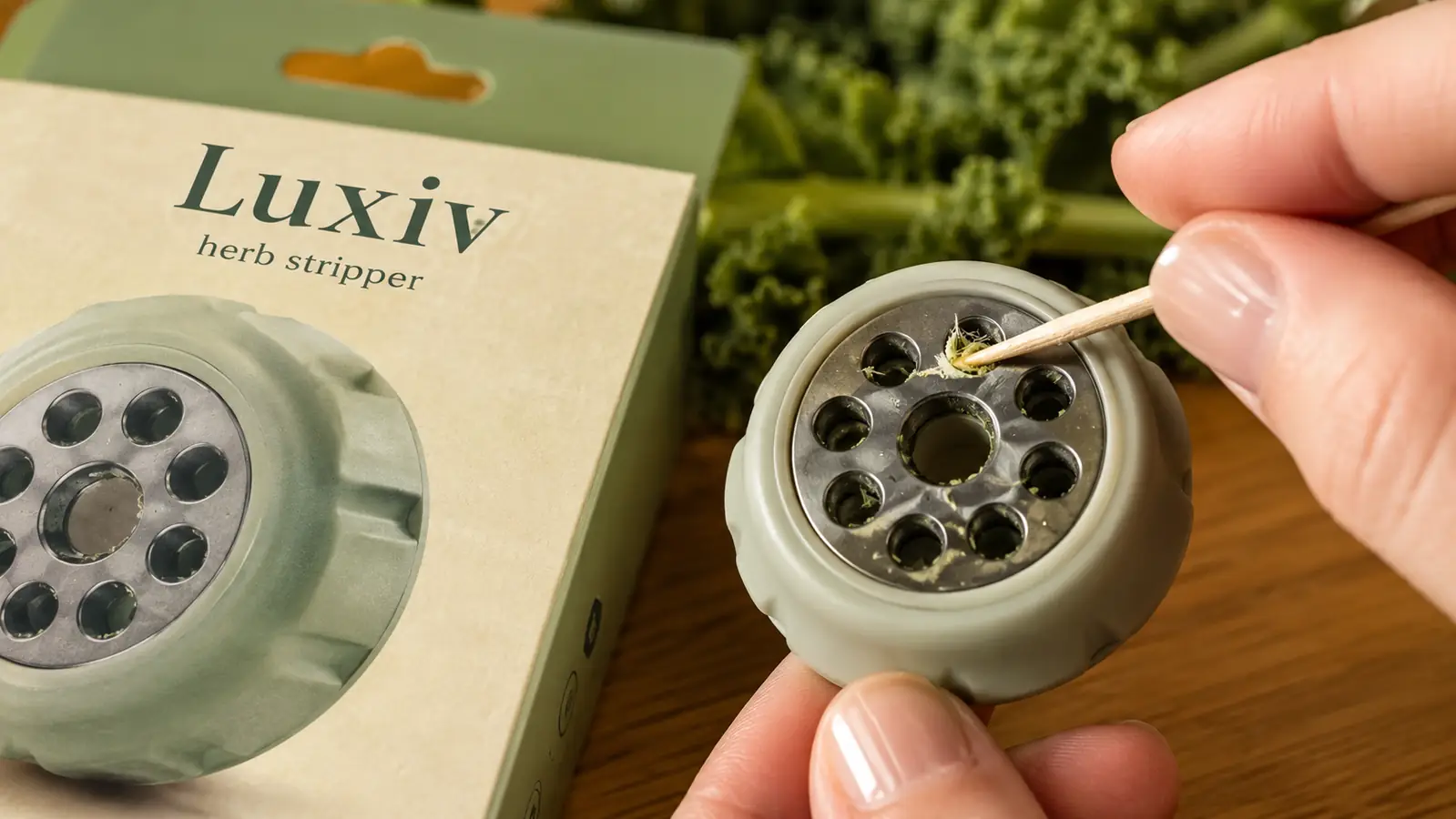 Close-up of the herb stripper's nine different-sized holes with a toothpick cleaning out stuck leaf fibers from one hole